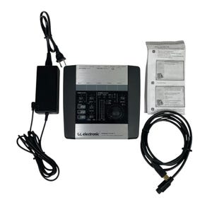 May include: A black and silver t.c. electronic desktop konnekt 6 audio interface with a power supply, cable, and manual. The interface has multiple input and output sections, a large dial, and various buttons and indicators.