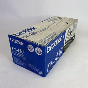 May include: A blue and white Brother TN-430 toner cartridge box. The box has the Brother logo and product information printed on it. The box is rectangular and has a slightly worn appearance.