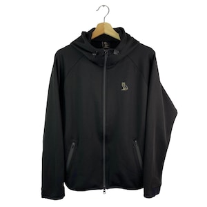 May include: Black zip-up hoodie with a hood and a small gold owl logo on the chest. The hoodie has two front pockets and a full-length zipper. It is hanging on a wooden hanger.
