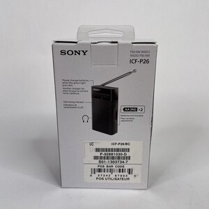 May include: A boxed black Sony ICF-P26 FM/AM radio. The packaging displays the Sony logo, product information, and an image of the radio with its antenna extended. The box also includes text about battery replacement and a tuning indicator.