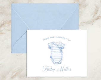 May include: A white rectangular note card with a light blue envelope. The card features a watercolor illustration of a blue and white striped baby bodysuit, with the text "FROM THE NURSERY OF" above and "Baby Miller" printed below.
