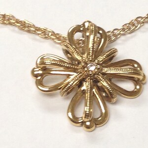 Gold toned pendant necklace with a beatiful cross shaped pendant