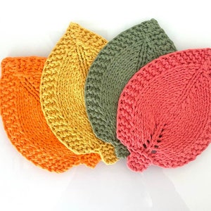May include: Four crocheted leaf-shaped pot holders in orange, yellow, green, and pink.