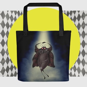 May include: A black tote bag with a dark blue background and a cartoon illustration of a creature with red eyes and a spotlight shining on it.