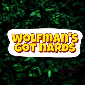 May include: A white sticker with a yellow and red text overlay. The text reads "Wolfman's Got Nards". The sticker is placed on a background of green leaves.
