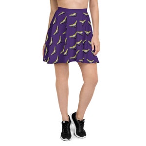 May include: A purple skater skirt with a pattern of yellow, purple, and white genderqueer pride flags.