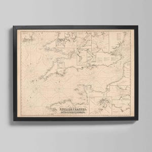 May include: Framed vintage map of the English Channel, featuring detailed nautical charts and geographical features. The map is printed on aged paper and encased in a black frame, suitable for home decor.