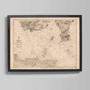 May include: Framed vintage map of Pentland Firth in sepia tones. The map features detailed coastlines, islands, and navigational markers. The black frame complements the antique aesthetic, making it a classic nautical decor piece.