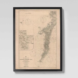 May include: A framed vintage nautical chart of the Hebrides and Western Isles. The chart is in shades of beige and gray, with detailed lines and symbols. The black frame complements the map's classic aesthetic, perfect for nautical decor.