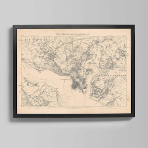May include: A framed vintage map of Southampton, England, from 1871. The map is in black and white, with intricate details of the town's layout, including streets, waterways, and surrounding areas. The frame is black.