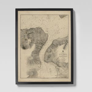 May include: Framed vintage map print of Kyle Rhea, with detailed topographical and nautical information. The map is in shades of beige and grey, encased in a black frame. A classic piece for nautical decor.