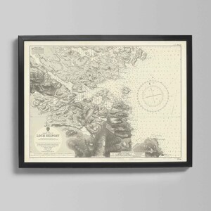 May include: Framed vintage nautical chart of Loch Skiport, Scotland, in black and white. The map features detailed coastlines, depth soundings, and a compass rose. The frame is black, and the print is mounted on a cream-colored background.
