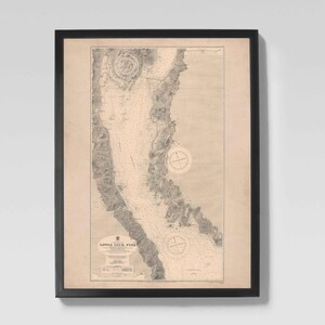 May include: Framed vintage nautical chart of Lower Loch Fyne, Scotland, in monochrome. The chart shows detailed coastlines, depth soundings, and navigational markers. The map is encased in a black frame, ready for display.