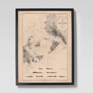 May include: Framed nautical chart of the Sound of Barra, featuring detailed coastlines, depth soundings, and navigational markers. The map is printed in black and white on aged paper, encased in a black frame. The chart includes compass roses and text.