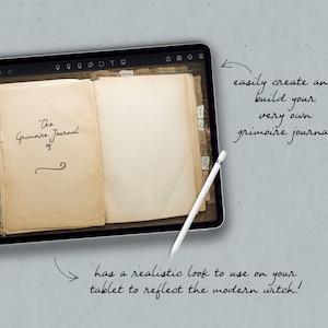 May include: A digital tablet displaying an open book with the title "The Grimoire Journal" on the left page. The tablet is on a gray background with handwritten text that reads "easily create and build your very own grimoire journal" and "has a realistic look to use on your tablet to reflect the modern witch!"