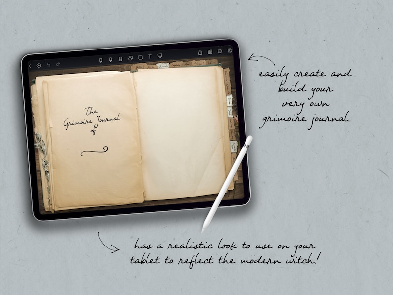 May include: A digital tablet displaying an open book with the title "The Grimoire Journal" on the left page. The tablet is on a gray background with handwritten text that reads "easily create and build your very own grimoire journal" and "has a realistic look to use on your tablet to reflect the modern witch!"