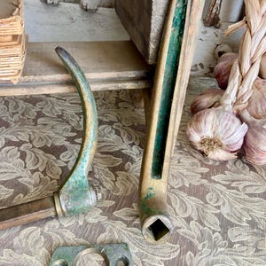 May include: Antique brass door hardware set with a green patina. The set includes a door handle, a door knob, and a strike plate.