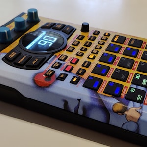 May include: A yellow and black drum machine with a blue and white graphic design. The drum machine has a digital display and a variety of buttons and knobs. The text "055CHOT ULTRA 320" is printed on the top right corner of the drum machine.
