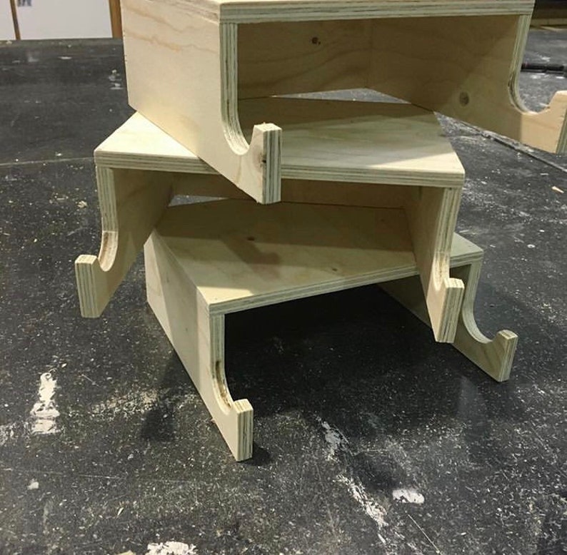 May include: Three unfinished wooden shelves with cutouts on the sides, stacked on top of each other.
