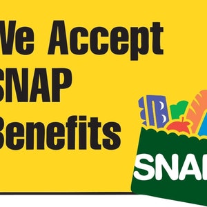 May include: A yellow sign with black text that reads "We Accept SNAP Benefits." A green grocery bag graphic is filled with groceries and the word "SNAP" is written on the bag.