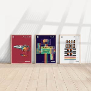 May include: Three framed art prints with minimalist designs. The prints feature electronic music themes: "Manchester 89" with a keyboard, "Berlin 91" with a circuit board, and "Bristol 93" with speakers. Each print has a wooden frame.