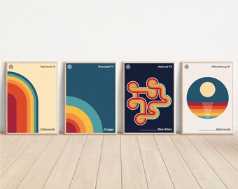 May include: Four framed retro posters with geometric designs and text. The posters feature a colour palette of orange, yellow, blue, and beige. Each poster has a unique design, including curved lines and a circular shape. The posters are displayed on a wooden floor.