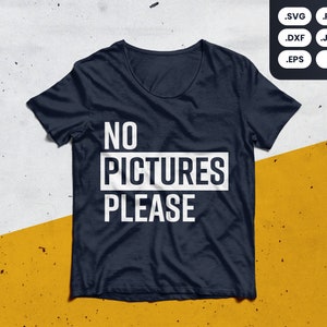 May include: A dark blue t-shirt with white text that reads "NO PICTURES PLEASE".