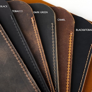 May include: Close-up of leather swatches in various colors, including chestnut, matte black, tobacco, dark green, camel, black & tobacco, and light tobacco. The swatches are arranged in a fan shape, with the stitching visible on each piece.