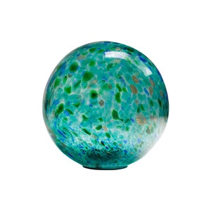 May include: A large, round, blue and green glass globe with a speckled pattern. The globe is made of clear glass with a variety of blue and green flecks throughout.