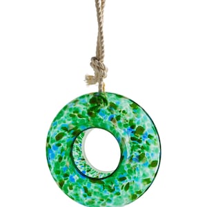 May include: A green and blue glass bird feeder shaped like a ring with a rope hanging from the top.