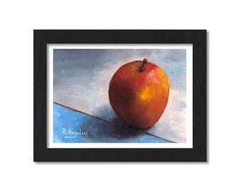 May include: An oil painting of a single red and yellow apple centered on a blue and white surface, enclosed in a black frame. The artwork features a visible signature by R. Angelini in the lower left corner, capturing light and shadow.