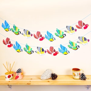 Colourful paper bunting with robins gold finches and blue tits
