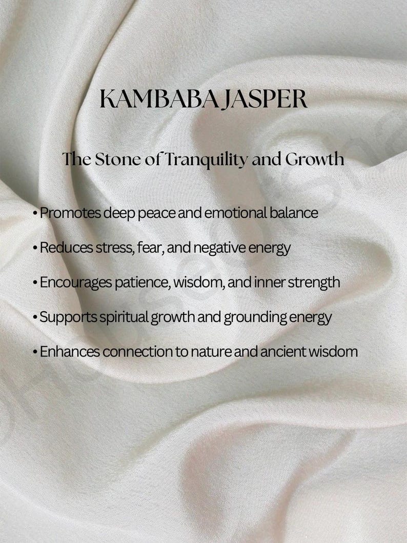 May include: Image featuring the text "KAMBABA JASPER" and "The Stone of Tranquility and Growth." The text is displayed on a white, textured fabric background. Bullet points list the stone's benefits, including promoting peace and reducing stress.