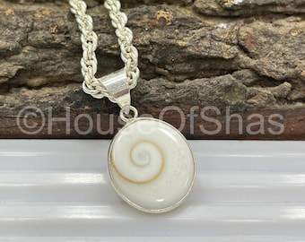 May include: A silver necklace with a pendant featuring a white, oval-shaped shell with a spiral design in the center. The chain is a twisted rope style. The pendant is approximately 1 inch in diameter.