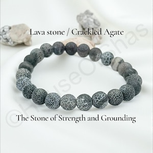 May include: A bracelet made of gray and black lava stone and crackled agate beads. The beads are round and have a textured appearance. The text "Lava stone / Crackled Agate" and "The Stone of Strength and Grounding" are displayed.