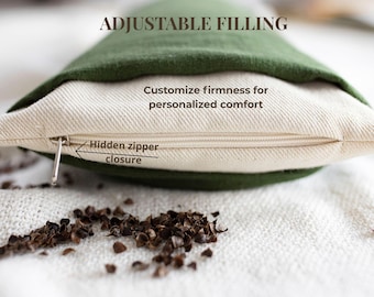 May include: A green and off-white pillow with a hidden zipper closure. The text ADJUSTABLE FILLING, Customize firmness for personalized comfort, and Hidden zipper closure are visible. Dark brown buckwheat hulls are scattered in the foreground.
