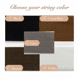 May include: Image showcasing a selection of string colors: Black, Corineilian, Grey, Brown, and White. The text "Choose your string color" is at the top. Each color is labeled with a letter and the color name.