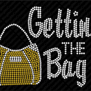 May include: Rhinestone design featuring a gold handbag with the text "Getting the Bag" in white rhinestones.