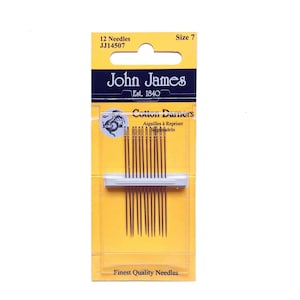 May include: A package of John James Cotton Darners needles, size 7, containing 12 needles. The package is yellow and clear, with the brand name and product details printed on the front. The needles are thin and brown.