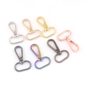 May include: Seven metal swivel clasps in various finishes, including silver, gold, rose gold, and iridescent.