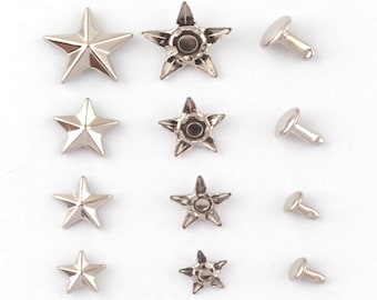 May include: Assortment of silver-toned metal star-shaped and round studs with prongs. The studs are arranged in rows on a white background.