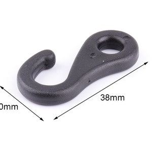 May include: Black plastic hook with a 38 mm length and 20 mm width. The hook is designed for securing items and has a rounded shape.