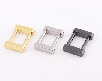 May include: Three metal D-ring buckles in gold, silver, and black.