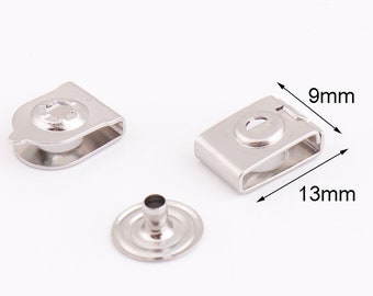 May include: Silver metal snap fasteners with a 9mm by 13mm measurement. The fasteners are designed for attaching fabric or leather.