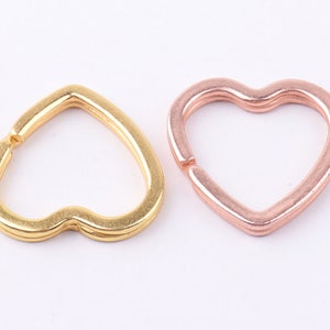 May include: Two heart-shaped keychains, one gold and one rose gold.