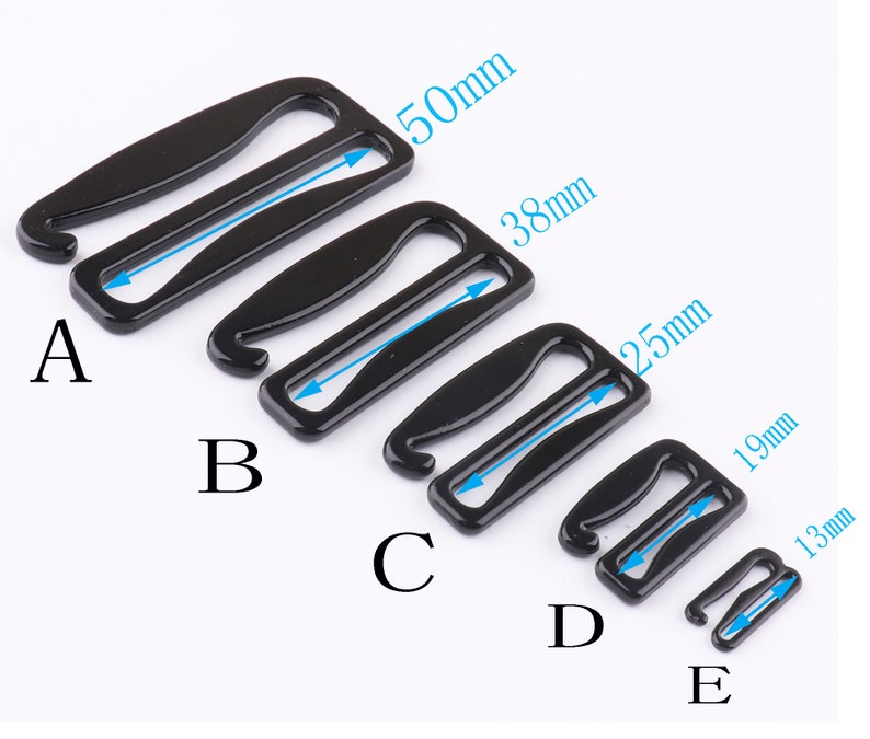 May include: Five black metal bra strap extenders in different sizes. The extenders are labeled A through E, with the largest being 50mm and the smallest being 13mm.