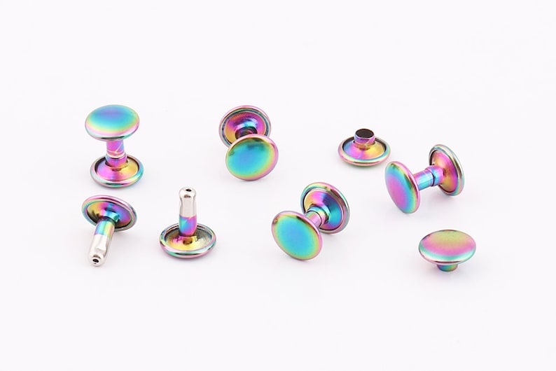 May include: Assortment of rainbow iridescent metal rivets, some with a post and some with a flat back.