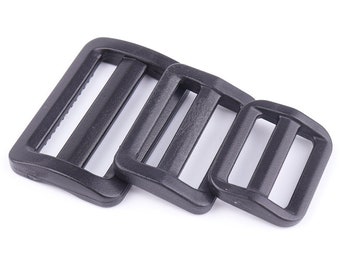 May include: Three black plastic slider buckles of different sizes. The buckles are designed to be used with webbing or straps.