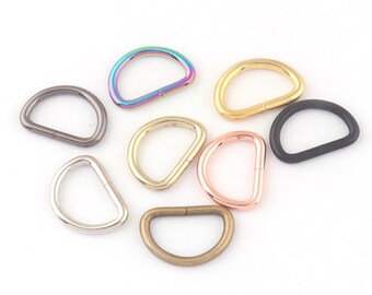 May include: Assortment of metal D-rings in various colors, including rainbow, gold, silver, and black. These rings are great for crafting, jewelry making, and other DIY projects.