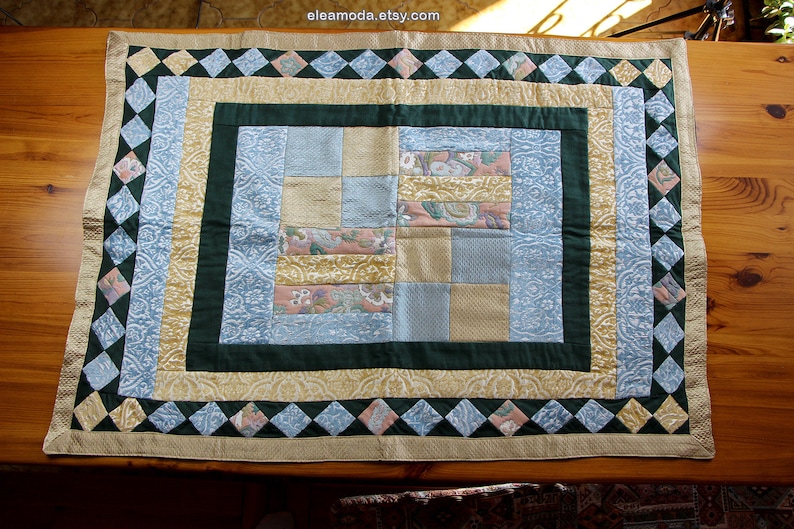 Quilted table mat in yellow and blue floral velvet for children.